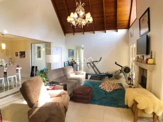 Sala de estar ampla com sofá e lareira em ambiente de madeira.
