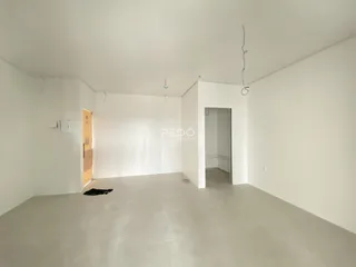 Imagem de uma sala ampla e vazia em uma propriedade.