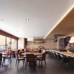 Vista interna de um espaço com mesas e cadeiras em um ambiente de jantar.