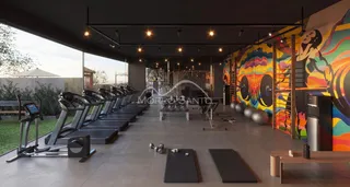 Foto de uma área de ginástica interna com esteiras e equipamentos de musculação.