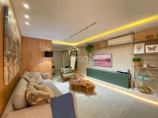Sala de estar moderna com painéis de madeira e sofá claro.