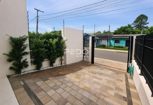 Parede branca da propriedade com piso de tijolos no exterior.