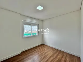 Sala de estar com piso de madeira e janela.