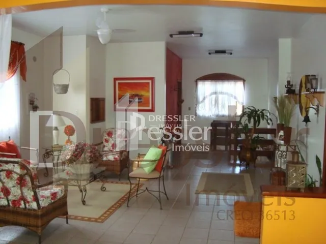 Sala de estar com piso de madeira e móveis.