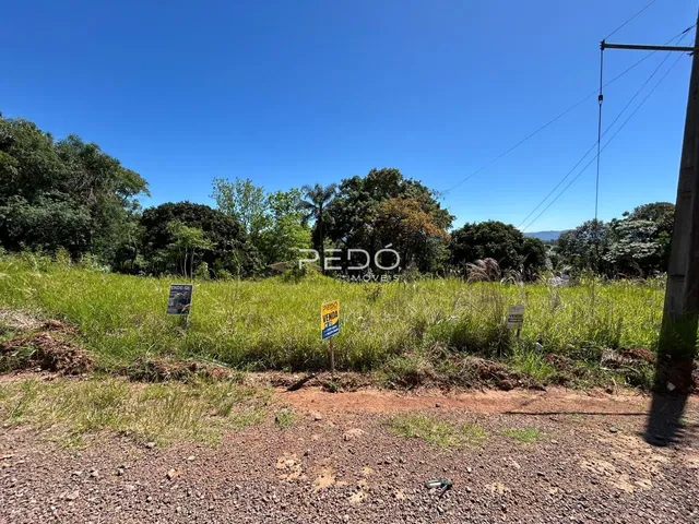 Paisagem de campo com vegetação e sinais em uma área de terra.