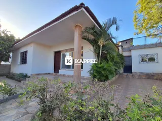 Fachada de uma casa residencial em Lajeado, Brasil, com telhado de telhas e área externa pavimentada.