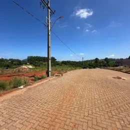 Vista externa de uma área pavimentada com blocos no terreno.