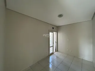Ambiente interno de uma sala com piso de cerâmica clara.
