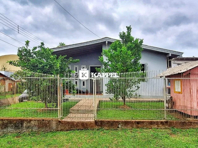 Fachada de uma casa em Lajeado, Brasil, com cerca e jardim.