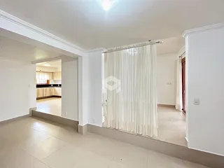 Ambiente interno de uma sala de estar com piso de cerâmica clara.