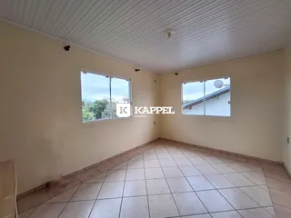 Sala de estar com piso de cerâmica e janelas.