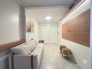 Sala de estar com sofá e parede de madeira em um imóvel no Brasil.