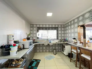 Foto de uma cozinha com armários e bancadas em um apartamento.