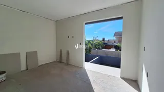 Ambiente interno com paredes brancas e piso de concreto.