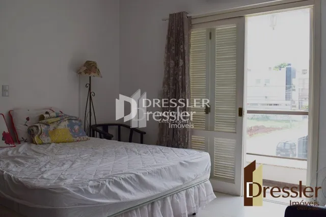 Quarto com cama e janela em ambiente interno.