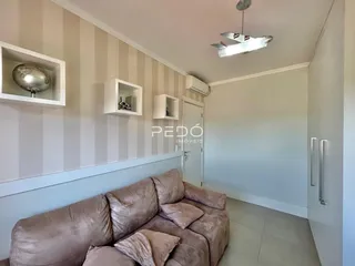 Sala de estar com parede listrada e sofá marrom.