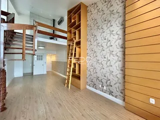 Hall de entrada com piso de madeira e parede decorada em Lajeado.