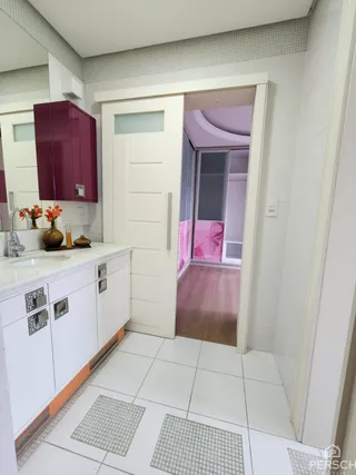 Cozinha com armários brancos e piso de cerâmica em um imóvel.