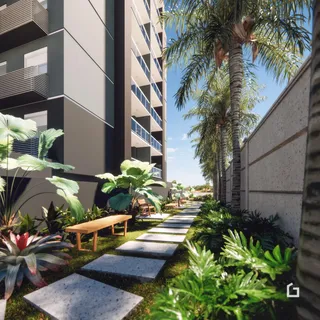 Jardim com caminho de pedras e banco ao lado de um prédio residencial em Lajeado.