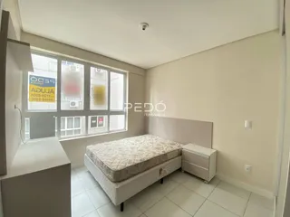 Quarto com cama e janela.