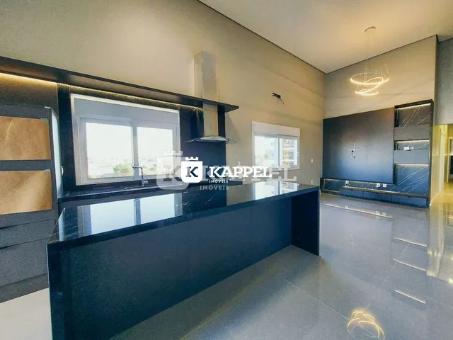 Foto de uma cozinha moderna com ilha escura e grande janela.