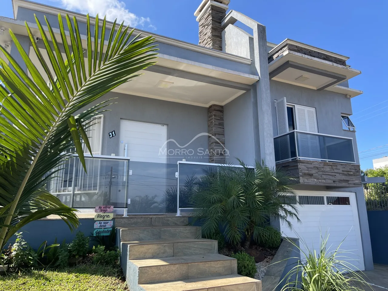 Fachada de uma residência moderna com jardim tropical em Lajeado, Brasil.