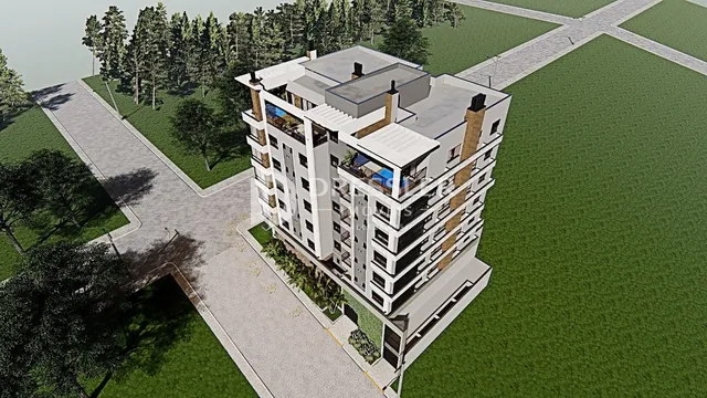 Vista aérea de um edifício residencial em Lajeado, Brasil, cercado por árvores e gramado.