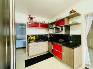 Cozinha moderna com armários de madeira e bancadas escuras.