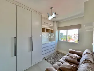 Sala de estar com armários brancos e janela de vista para a paisagem.