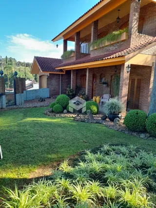 Fachada de casa com jardim e gramado em Lajeado, Brasil.