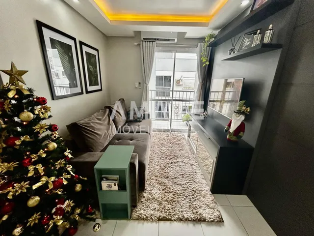 Sala de estar decorada com árvore de Natal e sofá.
