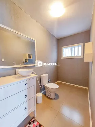Banheiro com bancada de pia e vaso sanitário.