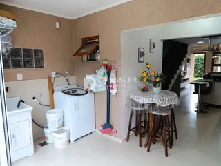 Interior de um cômodo com pia e eletrodomésticos brancos.