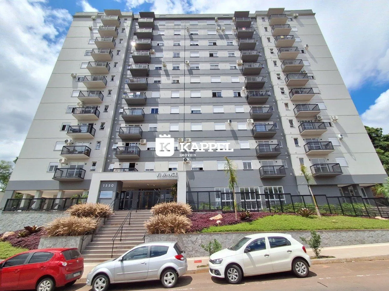 Fachada de um prédio residencial moderno em Lajeado, Brasil, com vários terraços e paisagismo.