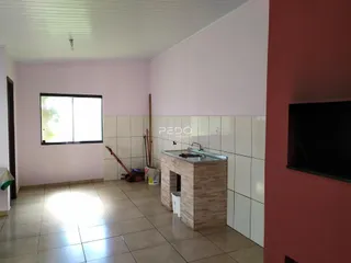 Interior de uma sala com piso de cerâmica e uma bancada de cozinha.