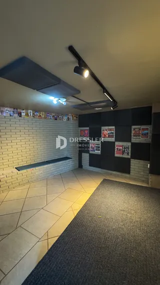 Hall de entrada com piso de cerâmica e parede de tijolos.