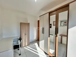 Quarto interno com armários e espelho em um imóvel no Brasil.