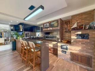 Ambiente de sala de estar com cozinha em um imóvel no Brasil.