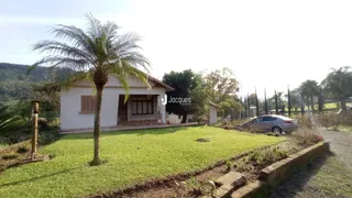 Fachada de casa em Lajeado com jardim gramado e palmeira.