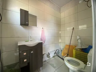 Foto de um banheiro com revestimento de azulejos brancos.