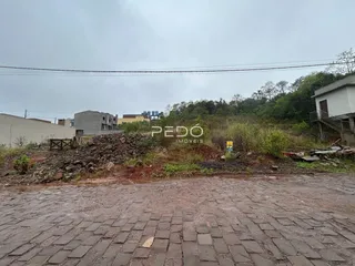 Vista externa de um terreno com vegetação e entulho em Lajeado, Brasil.