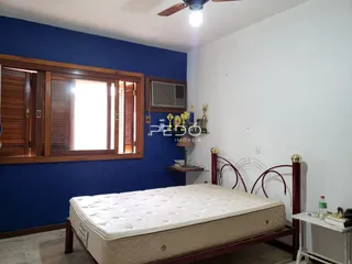 Quarto com cama de dossel e parede azul na residência.