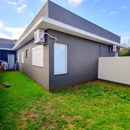 Fachada externa de uma casa moderna com jardim gramado em Lajeado, Brasil.