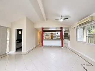 Vista de um corredor interno com piso de cerâmica claro.
