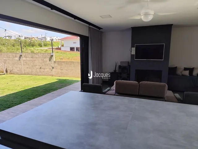 Sala de estar com vista para o quintal e cerca de madeira.