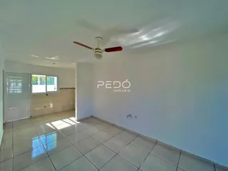 Interior de uma sala com piso de cerâmica e janela.