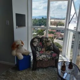 Poltrona decorativa com estofamento floral em uma sala de estar.
