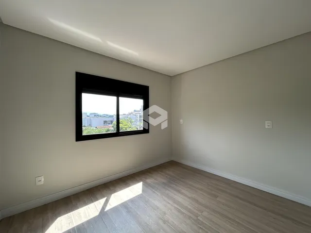 Sala de estar com vista para a paisagem urbana através de uma janela.