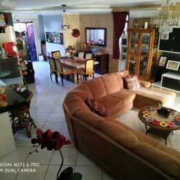 Foto de uma sala de estar com um sofá marrom e móveis de madeira.