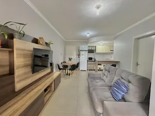 Sala de estar com sofá e painel de madeira na residência.